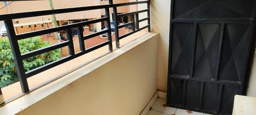 a balcony with a black door and a window at Waiyaki Way homes in Rungiri