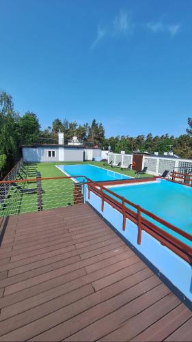 a large swimming pool on the roof of a building at APARTAMENT 15B BLUE MARINE Poddąbie Basen Odkryty Brodziki Plac Zabaw in Poddąbie