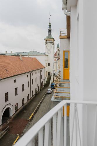 a view from the balcony of a building with a clock tower at Apartmány Prusinovského in Kroměříž