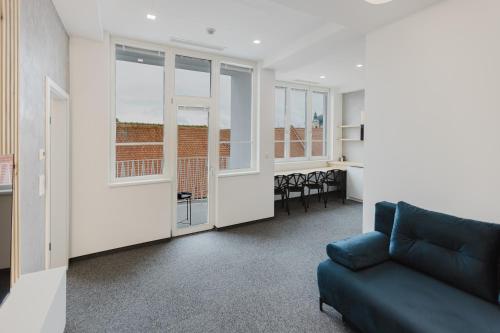 a living room with a couch and a table at Apartmány Prusinovského in Kroměříž