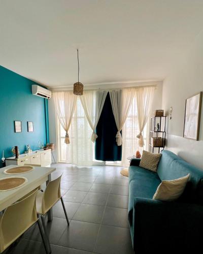 a living room with blue walls and a blue couch at Surfing Ocean View Appartment in Sal Rei