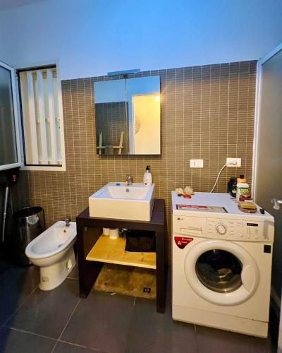a bathroom with a washing machine and a sink at Surfing Ocean View Appartment in Sal Rei