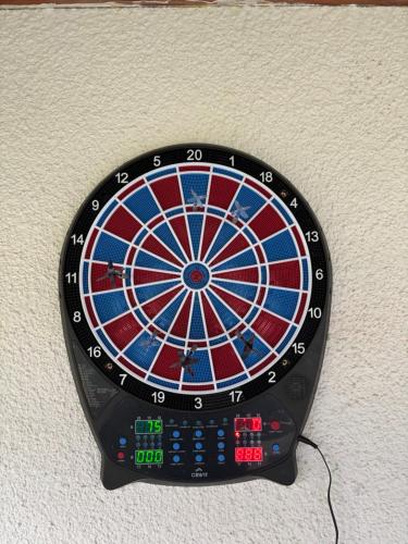 a dart board is attached to a wall at Lake View Cottage - Zavojsko jezero in Zavoj