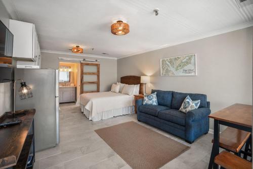 a living room with a bed and a blue couch at 520 Sunsuite in Fripp Island