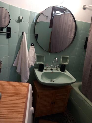 a bathroom with a sink and a mirror and a tub at Elmar House in Paralion astros