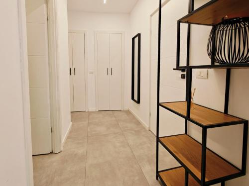 a hallway with white cabinets and a shelf at Old Town cozy apartments Brătianu - Pumo Properties in Bucharest