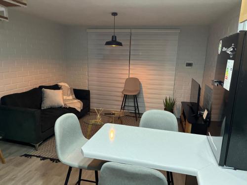 a living room with a white table and chairs at Casa equipada Vallenar in Huasco