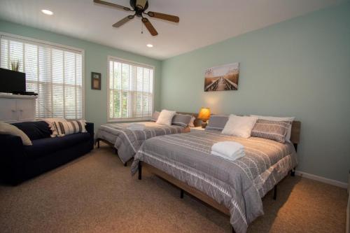 a bedroom with two beds and a couch at 83 Ocean Creek Blvd in Fripp Island