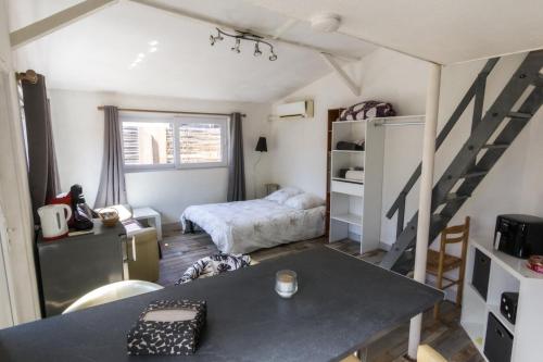 a small room with a bed and a table in it at Studio - Les Capucins in Riom