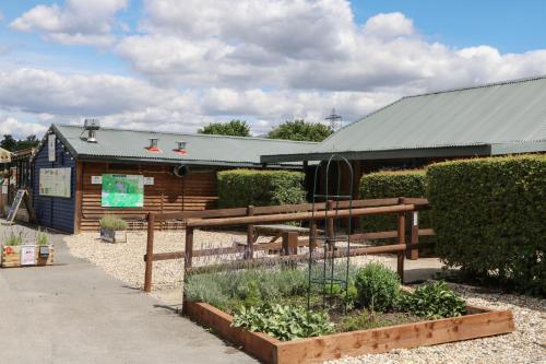 a garden in front of a wooden building at 18 Deer Glade in Salisbury