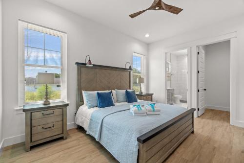 a bedroom with a large bed with blue pillows at Brand New Home with In-ground Pool, Four Houses From Beautiful Laguna Beach in Laguna Beach