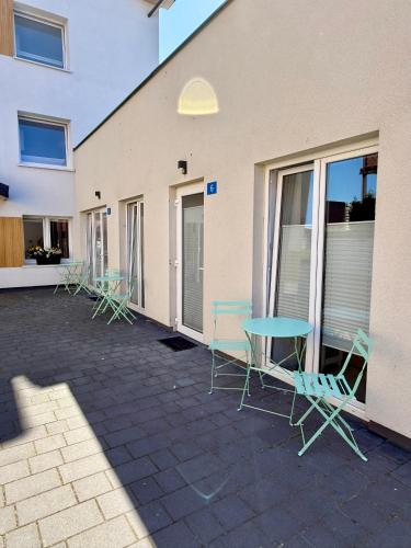 a patio with chairs and a table in front of a building at Apartamenty Sunny Stay Jastarnia in Jastarnia