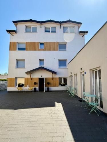 a large white building with a patio in front of it at Apartamenty Sunny Stay Jastarnia in Jastarnia