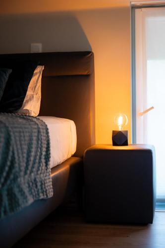 a bedroom with a bed and a candle on a table at De Weldoeninge in Wingene