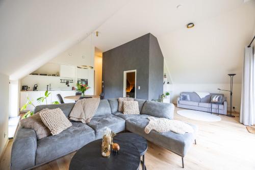 a living room with a couch and a table at De Weldoeninge in Wingene