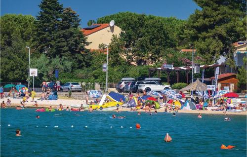 a group of people in the water at a beach at Amazing Home In Sveti Filip I Jakov in Sveti Filip i Jakov