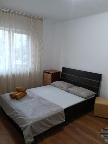 a bedroom with a bed with a teddy bear on it at Spital studio Mureșului in Târgu-Mureş