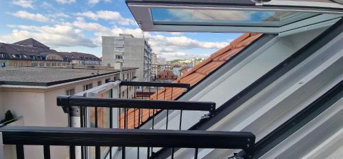 a balcony with a view of a city at Hotel de France in La Chaux-de-Fonds