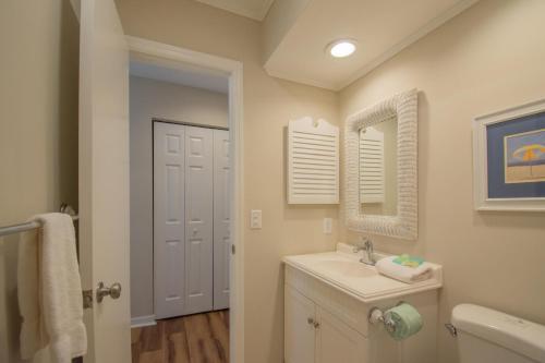 a bathroom with a sink and a mirror at 102 Capt John Fripp Villa in Fripp Island