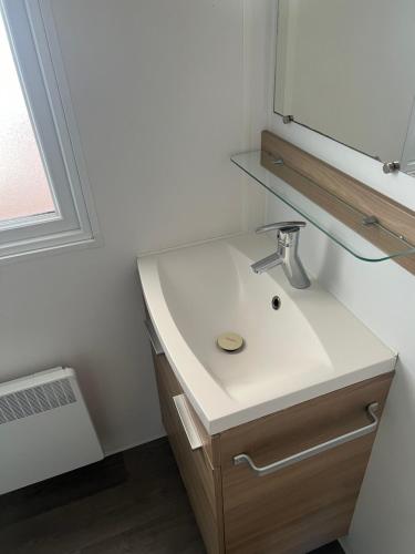 a bathroom with a sink and a mirror at mobil home ronce le bain in La Tremblade