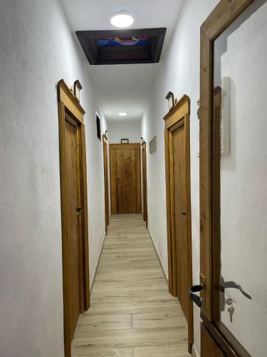 a hallway with two wooden doors and a hallwayngth at Casa Los Templarios, cerca de Puy du fou in Burujón