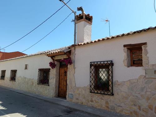 a white building with a cross on top of it at Casa Los Templarios, cerca de Puy du fou in Burujón