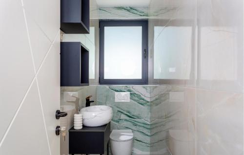 a bathroom with a sink and a toilet and a window at Lovely Home In Opric With Wifi in Opric