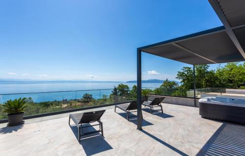 a patio with two chairs and a hot tub on a roof at Lovely Home In Opric With Wifi in Opric