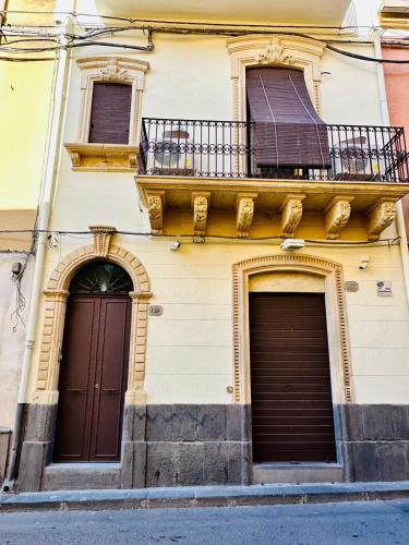 a building with two doors and a balcony at Dimora Barocca in Militello in Val di Catania