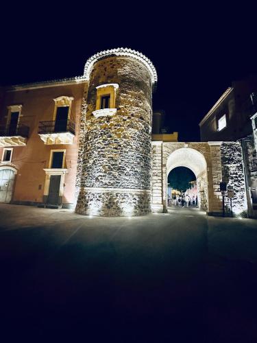 a stone building with an arch in front of it at Dimora Barocca in Militello in Val di Catania