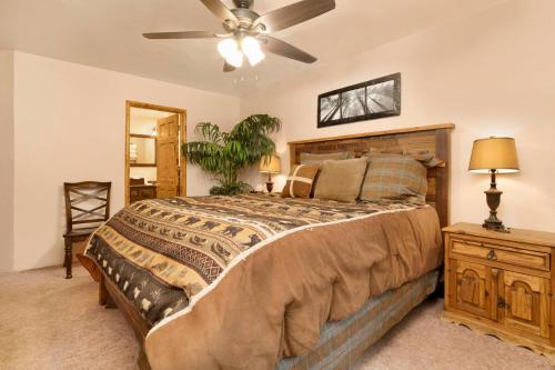 a bedroom with a large bed and a ceiling fan at Swiss delight #2244 in Big Bear Lake