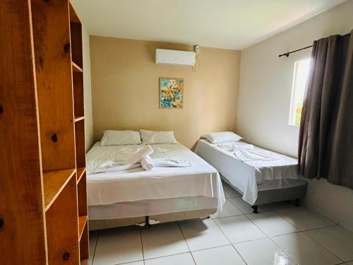 Postel nebo postele na pokoji v ubytování Casa Temporada Suítes