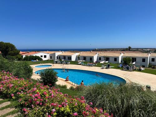 a view of a swimming pool in a resort at Costa Arenal 112 in Arenal d'en Castell