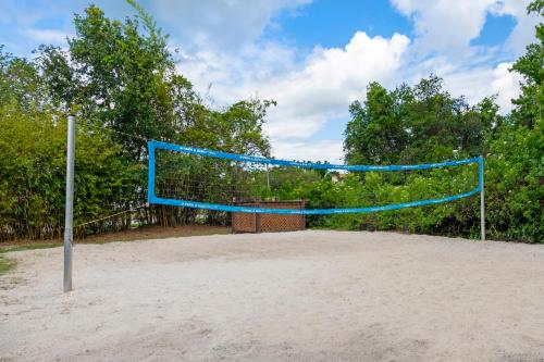 a volleyball net in the sand on a beach at Parkway International Resort in Orlando