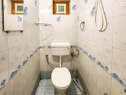 a bathroom with a toilet in a room at The Plix Villa in Anjuna