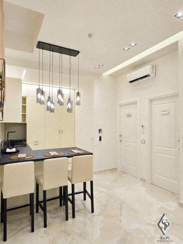 a kitchen with a table and chairs in a room at SOPI Home in Castellammare di Stabia
