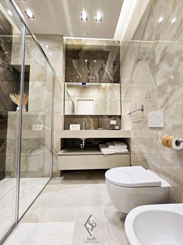a bathroom with a shower and a toilet and a sink at SOPI Home in Castellammare di Stabia