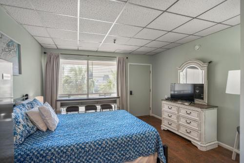 a bedroom with a bed and a television and a dresser at 532 Sunsuite in Fripp Island