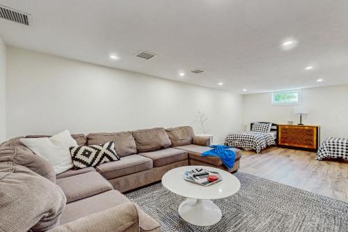a living room with a couch and a table at Saggie Beach Hideaway in Sagamore Beach