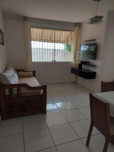 a living room with a bed and a television at Apartamento em Capim Macio com 03 quatros e cinco camas perto da praia in Natal