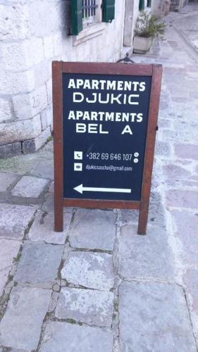 a sign sitting on the side of a street at Balcony with Old Town view in Kotor