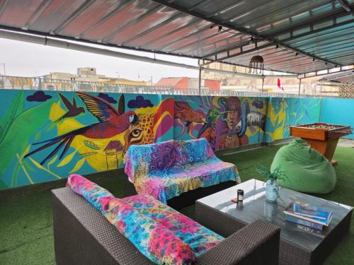 a room with two couches and a colorful mural at Alojamiento San Francisco - Apartamentos y habitaciones in Lima