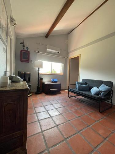 a living room with a couch and a table at O Cantinho Alojamento Local in Luso