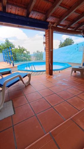 a patio with chairs and a swimming pool at O Cantinho Alojamento Local in Luso