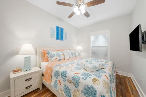 a bedroom with a bed and a ceiling fan at Laguna Peach: 3BA 2BA retreat for 10! Explore nearby beaches & activities in Laguna Beach