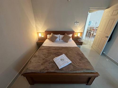 a bedroom with a bed with a towel on it at NK Homes - Full Furnished Serviced Apartments in Hyderabad