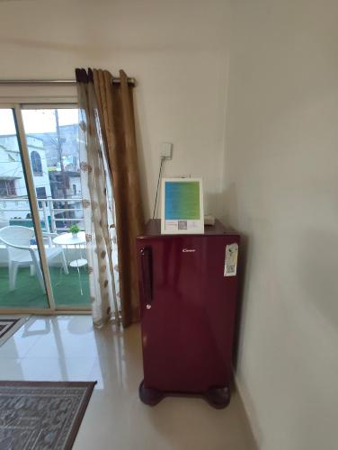 a laptop computer sitting on top of a brown refrigerator at NK Homes - Full Furnished Serviced Apartments in Hyderabad