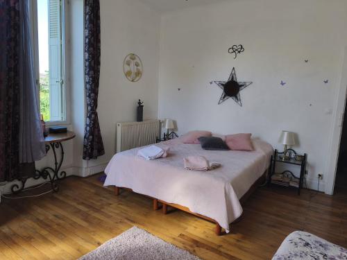 a bedroom with a bed and a star on the wall at VILLA DE SOUZA in Bouillé-Loretz