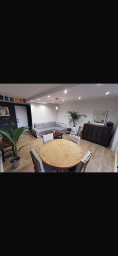 a living room with a wooden table and a couch at Chambre chez nous! Au calme, Montolivet proche métro in Marseille