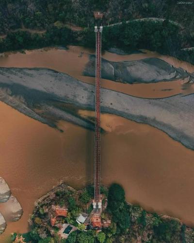 an aerial view of a river with a building in the middle at Hotel Santa Fe del Parque in Santa Fe de Antioquia